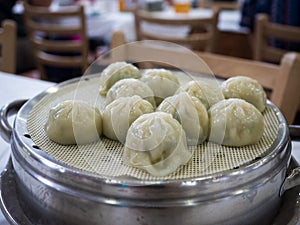 Jjin mandu, or Korean style steamed dumpling filled with a mixture of ingredients including ground pork, kimchi, vegetables.