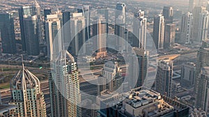 JLT skyscrapers near Sheikh Zayed Road aerial timelapse. Residential buildings and villas behind