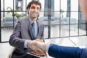 Job applicant having interview. Handshake while job interviewing.