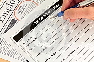 Job Description and Hand with Pen