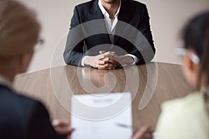 Job interview concept, african male job applicant talking to recruiters