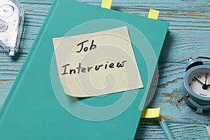 Job interview concept. Composition of notebooks, pens, pencil, stickers on a colored background.