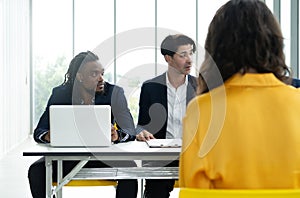 Job interview concept. Diverse hr team doing job interview with a man in business office. Human resources team interviewing a