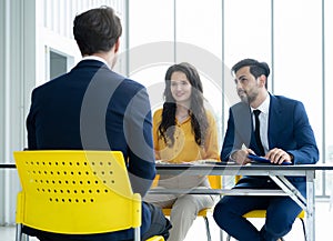 Job interview concept. Diverse hr team doing job interview with a man in business office. Human resources team interviewing a