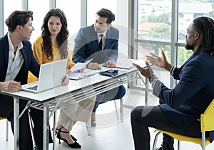 Job interview concept. Employer and diverse hr team doing job interview with a black man in business office. Job candidate talks