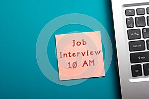 Job interview concept. Office table top view - Laptop and reminder.