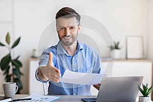 Job Interview. Friendly male HR manager extending hand for handshake at camera