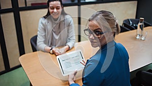 Job interview. The recruiter holds a tablet with a check list of the necessary skills of the candidate.