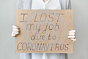 Job loss due to COVID-19 virus pandemic concept. Unrecognizable person holds sign