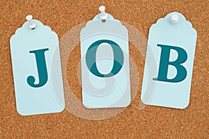 Job message on blue gift tags on a corkboard