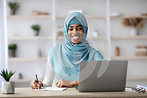 Job For Muslim Women. Black Islamic Female Sitting At Desk With Computer