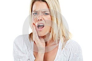 This is a job for my dentist. Studio portrait of a young woman experiencing toothache against a white background.