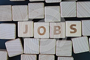 Job recruitment, career vacancy or hiring position in the company concept, cube wooden block with alphabet combine the word Jobs