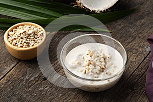 Boiled millet with coconut soup in glass bowl