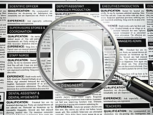 Job search concept. Loupe, newspaper with employment advertisements.