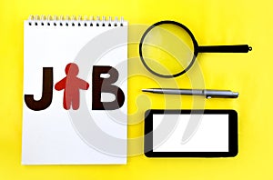 Job searching concept. Smartphone, magnifying glass, notebook and pen on yellow background