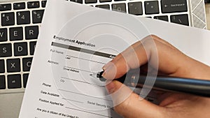 Job seeker filling up employment application form