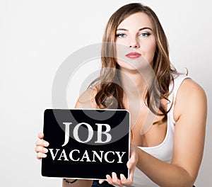 Job vacancy written on virtual screen. beautiful woman with bare shoulders holding pc tablet. technology, internet and