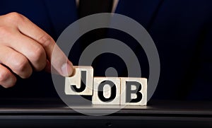 JOB word wooden block arrange in vertical style on white background and selective focus