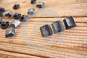 JOB wrote with keyboard keys on wooden background