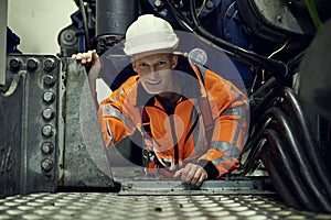 In this job, you get used to small spaces. Portrait of a young engineer at work while wearing safety gear.