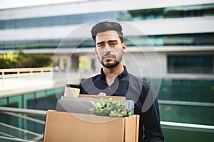 Jobless Arabian man with his belongings in carton box outdoor