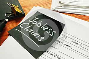 Jobless claims memo stick and pile of documents