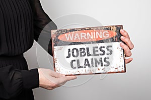 Jobless claims. Warning sign in woman& x27;s hand