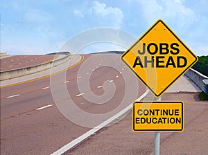 JOBS AHEAD CONTINUE EDUCATION road sign positive message of success