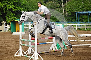 Jockey in glasses jump on horse