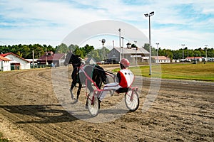 Jockey and horse. Trotting horse race. Race in harness with a sulky or racing bike. Harness racing. Trotting horse race