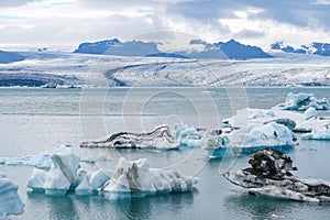 joekulsar lagoon with icebergs and eroding glacier in Iceland