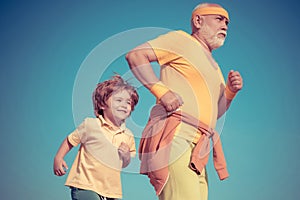 Jog and run marathon for family. Grandpa and child sportsmen jogging outdoors and enjoying sunny day. Grandpa and