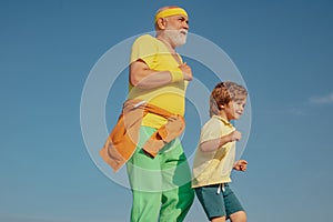 Jog and run marathon for family. The old and young sportsmen running on the road. Portrait of healthy senior sport man