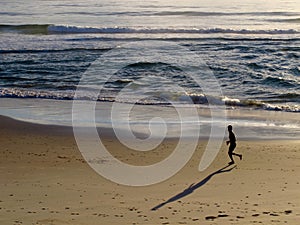 Jogger on Beach at Sunrise