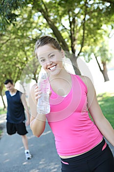 Jogger Drinking Water in Park