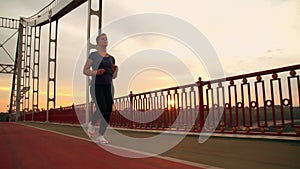 Jogger female run on the bridge