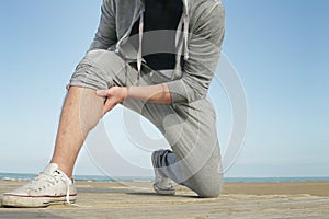 Jogger having a cramp and muscle pain photo