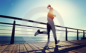 Jogger morning exercise on seaside boardwalk during sunrise