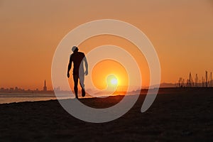 Jogger silhouette walking exhausted after a hard training photo