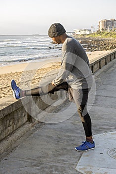 Jogger Stretching on Promonade by beach