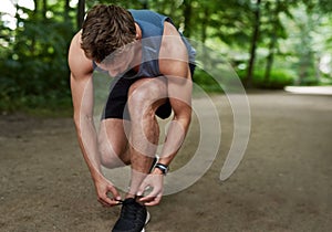 Jogger tying his shoe laces