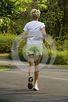 Jogging caucasian lady in park