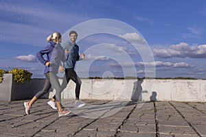Jogging Concepts. City Running Couple Having Jogging Outside as Runners During Training Outdoor Working Out Happily Smiling While