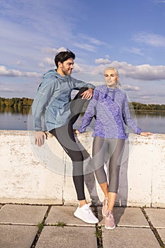 Jogging Concepts. One Positive Runners  Couple Posing Together At River Bank Outside as Runners During Training Relaxation Outdoor