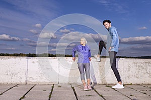 Jogging Concepts. One Positive Runners  Couple Posing Together At River Bank Outside as Runners During Training Relaxation Outdoor