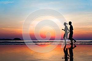 Jogging and healthy lifestyle, two runners silhouettes at sunset, workout and sport