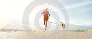 Jogging man with his dog in the morning. Active healthy lifestyle concept image