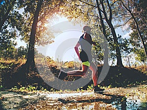 Jogging tall sports man in trees shadows with sun light behind