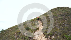 Jogging woman on mountain road. Sport girl exercising outside in mountains